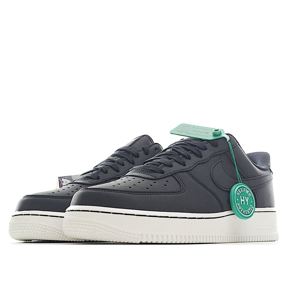 Nike Air Force 1 low-top sneaker, side view of dark upper with white sole and green lace