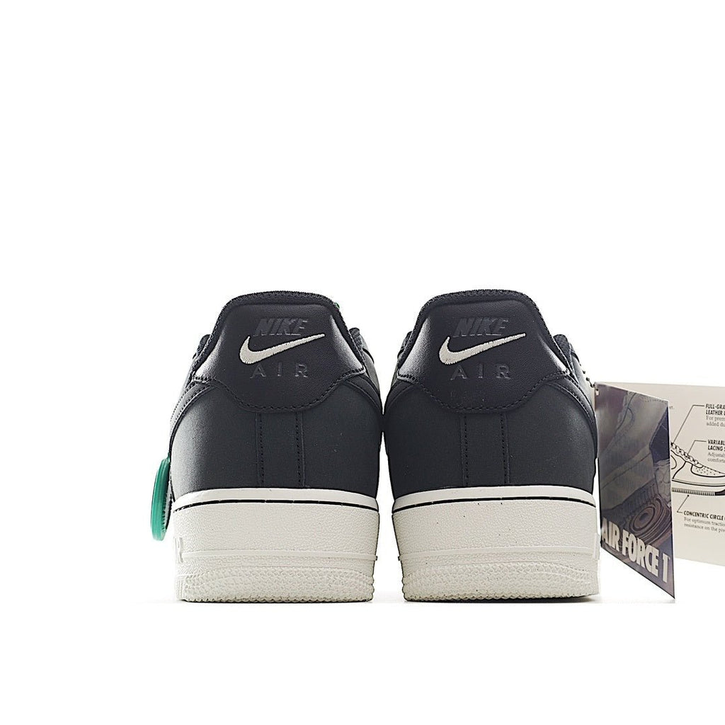 Nike Air Force 1 low-top sneaker pair, dark upper with white sole and green lace tag