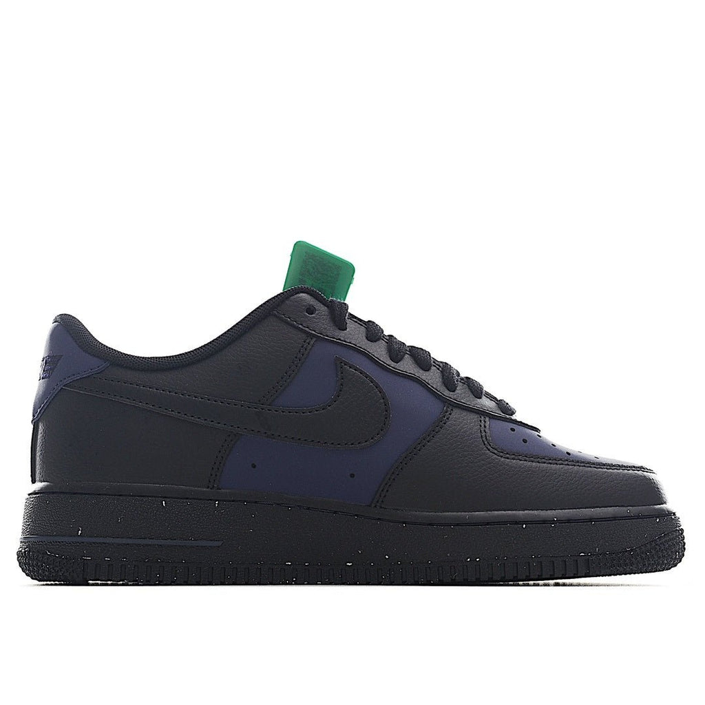 Navy and black low-top sneakers, side view with green hang tag