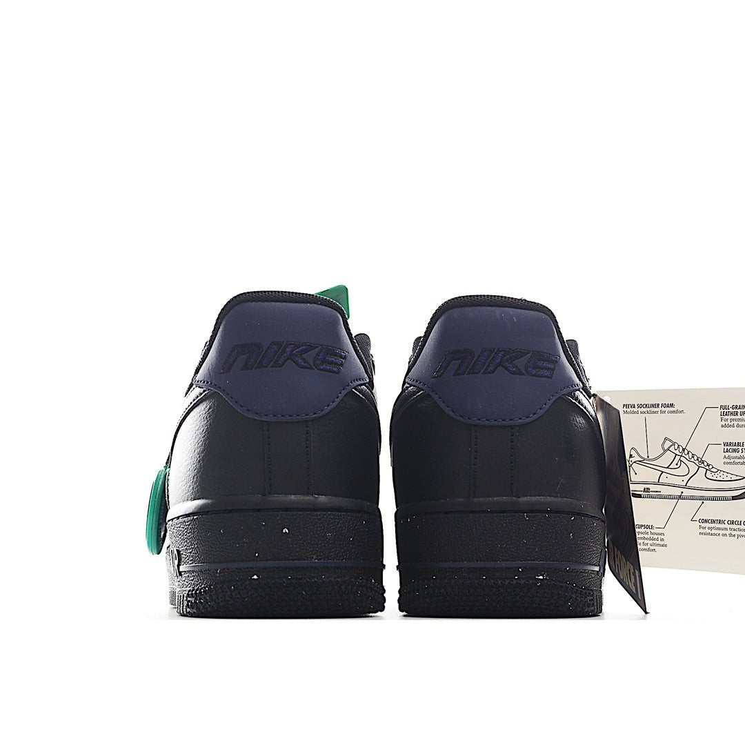 Navy and black low-top sneakers, back view