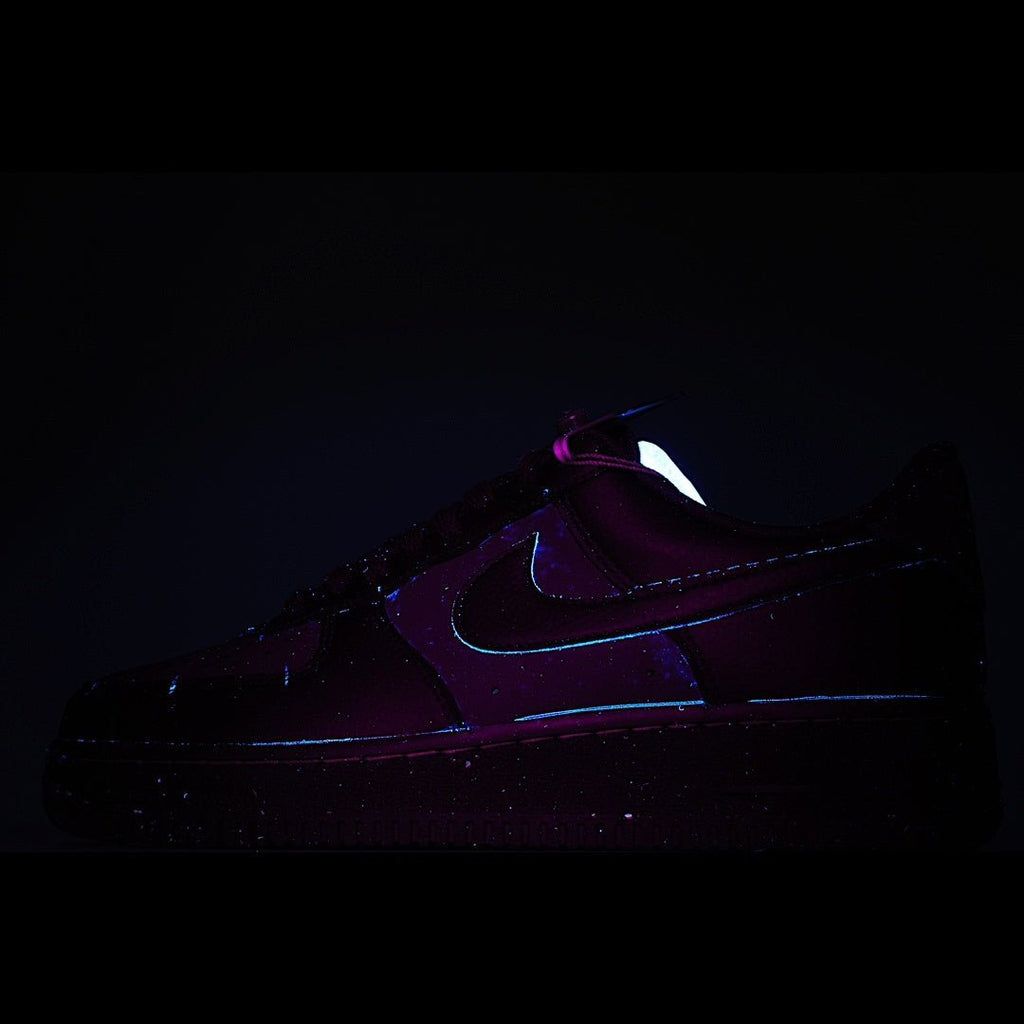 Dark purple low-top sneakers with Nike swoosh, side view