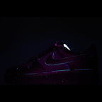 Dark purple low-top sneakers with Nike swoosh, side view