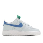 White Nike Air Force 1 low-top sneaker with blue side swoosh and mint heel tab