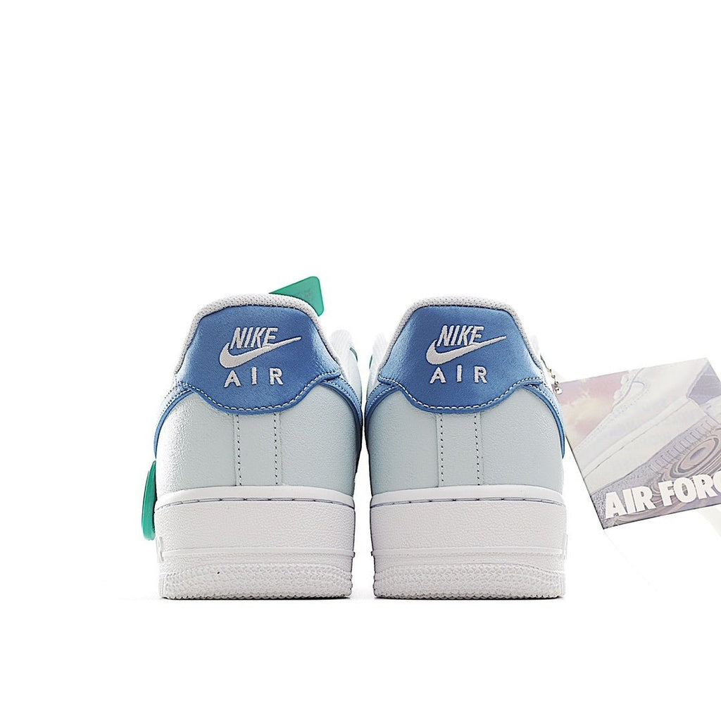 Light blue Nike Air Force 1 sneakers with NIKE AIR heel branding and mint accents