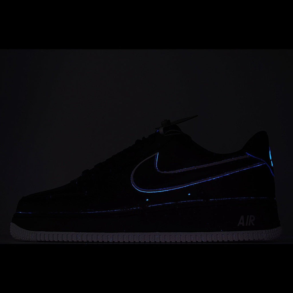Nike Air Force 1 sneakers, dark upper with blue glowing swoosh and AIR branding.