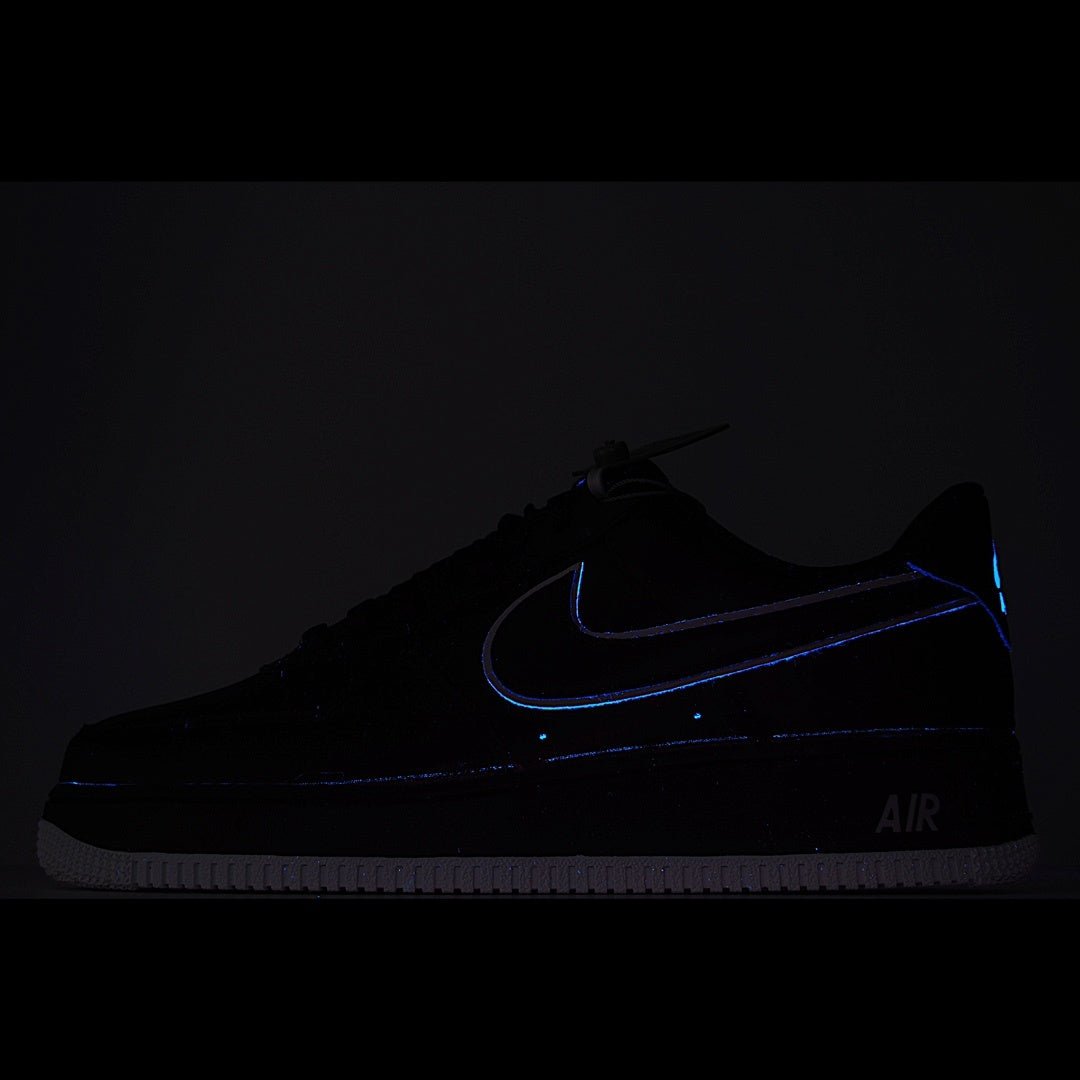 Nike Air Force 1 sneakers, dark upper with blue glowing swoosh and AIR branding.