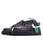 Low-top sneakers, black with white swoosh and green HY tag on the lace area