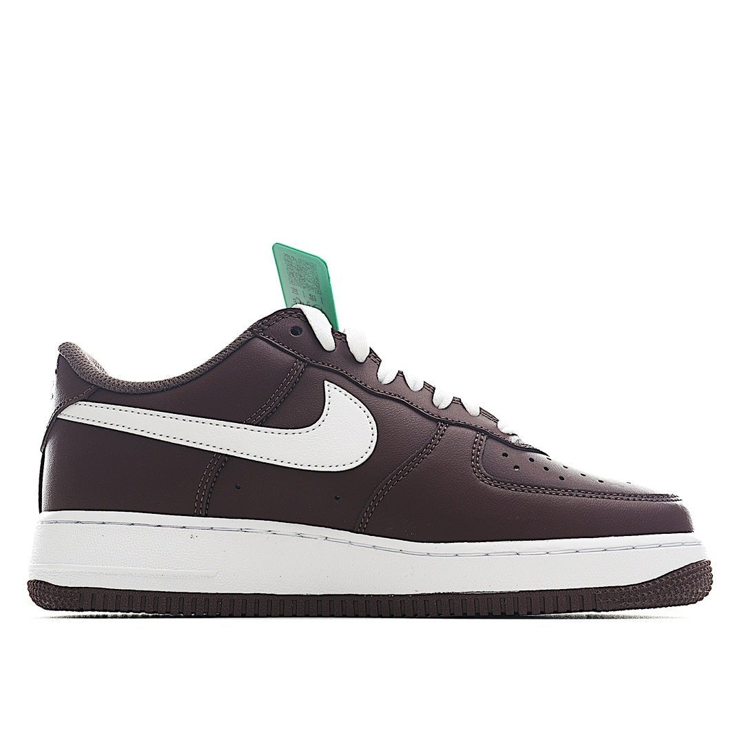 Brown Nike low-top sneaker with white swoosh, green tongue tag, and lace-up closure