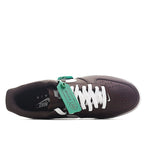 Brown low-top sneakers with white laces and green tag, Nike Air Force 1 style