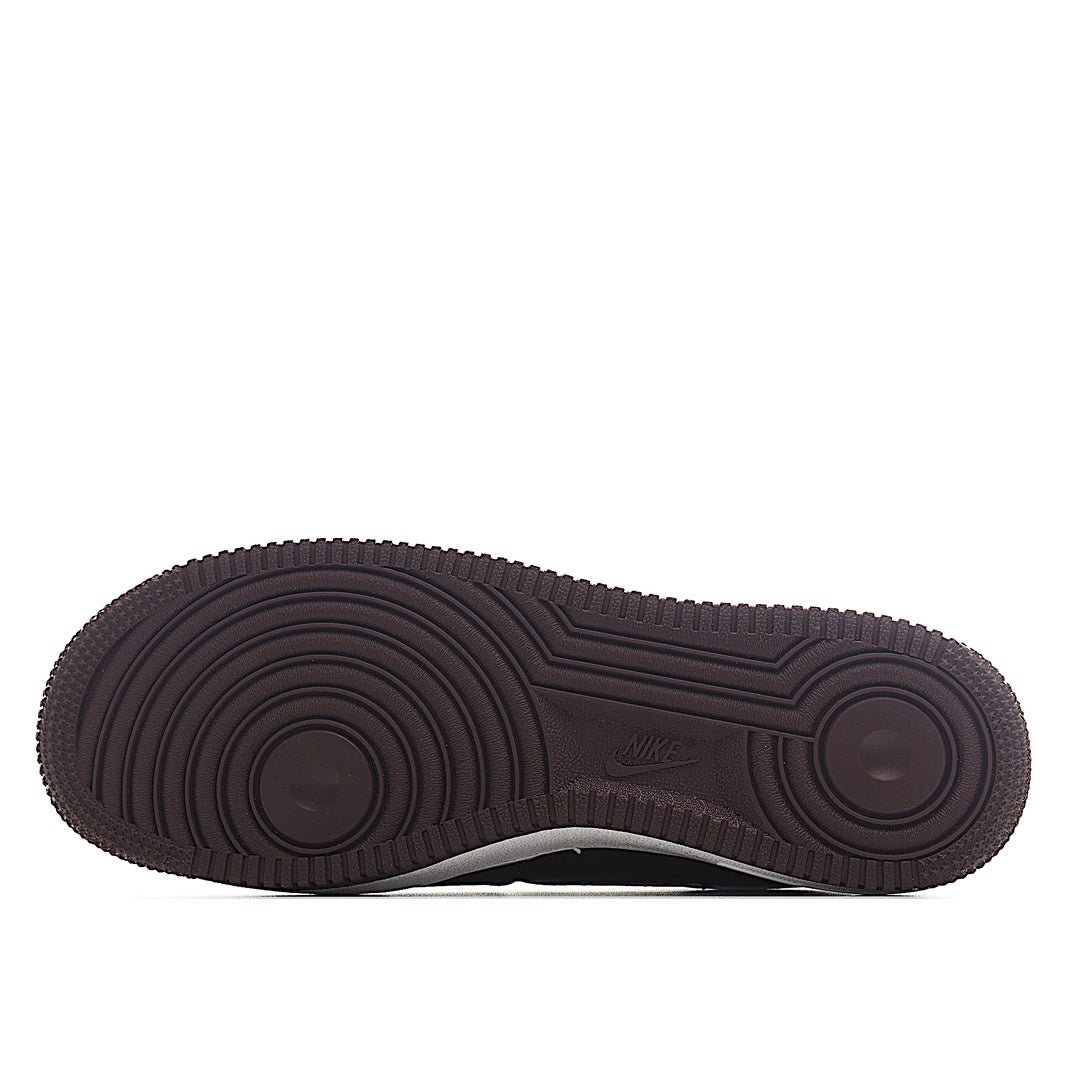 Brown outsole and tread of Nike low-top sneaker, circular traction pattern