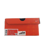 Orange Nike Air Force 1 shoe box with label and swoosh logo on top