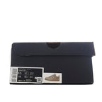 Black shoe box with white size label and product information sticker