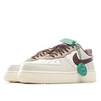 White Nike Air Force 1 low-top with brown heel panel and green lace detail