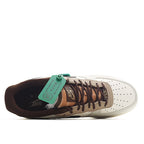 White Nike Air Force 1 low-top with brown laces and green tongue tag