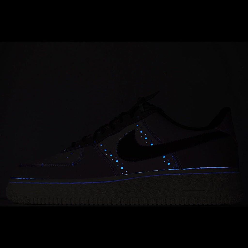 Dark Nike Air Force 1 sneaker with blue glowing accents on panels