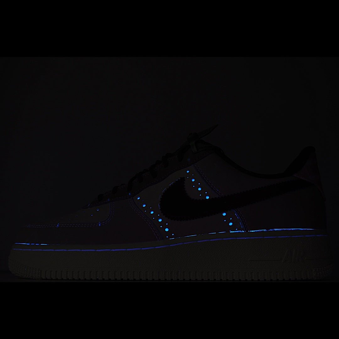 Dark Nike Air Force 1 sneaker with blue glowing accents on panels