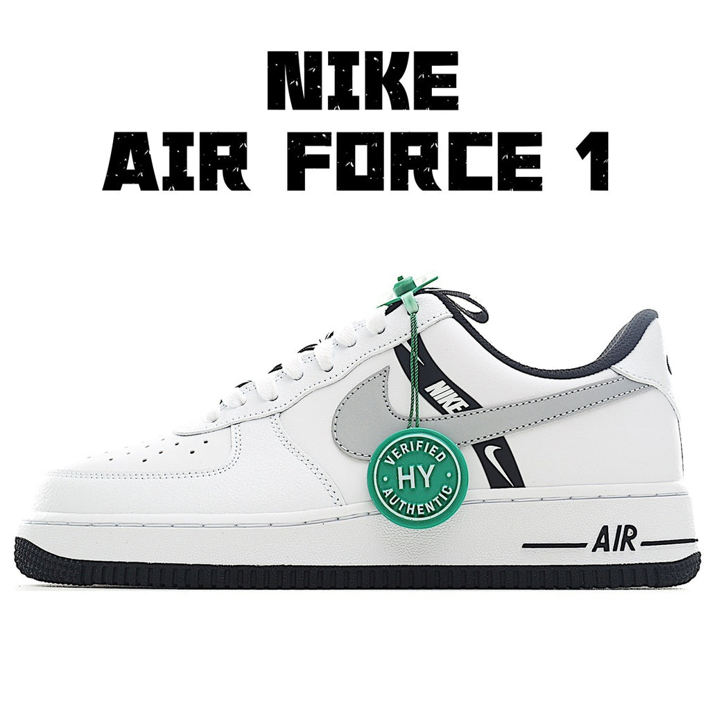 White Nike Air Force 1 sneakers with gray swoosh and green lace tag.