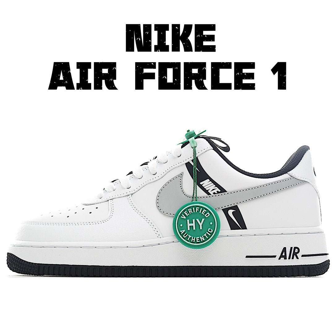 White Nike Air Force 1 sneakers with gray swoosh and green lace tag.