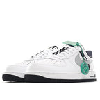 White Nike Air Force 1 sneakers with gray swoosh and green collar accents.