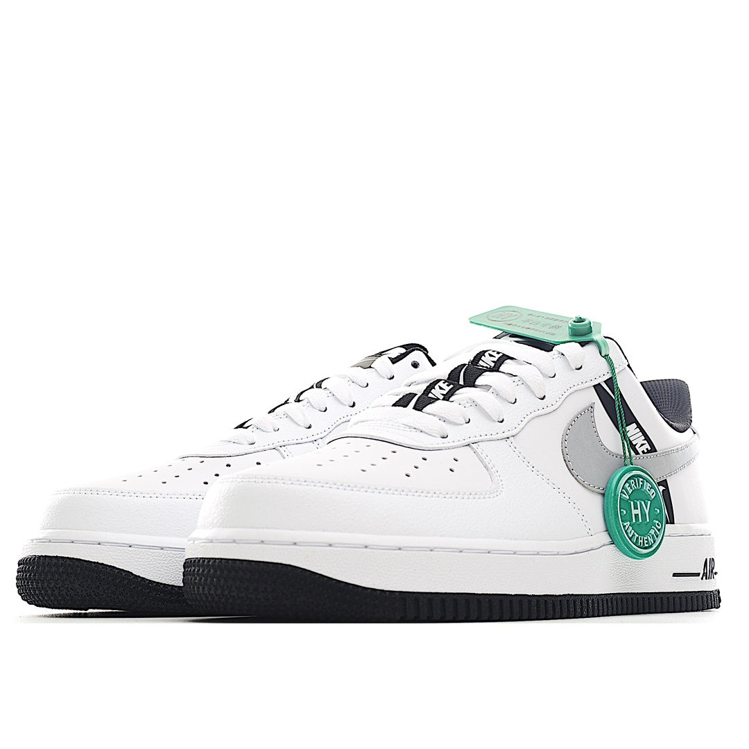 White Nike Air Force 1 sneakers with gray swoosh and green collar accents.
