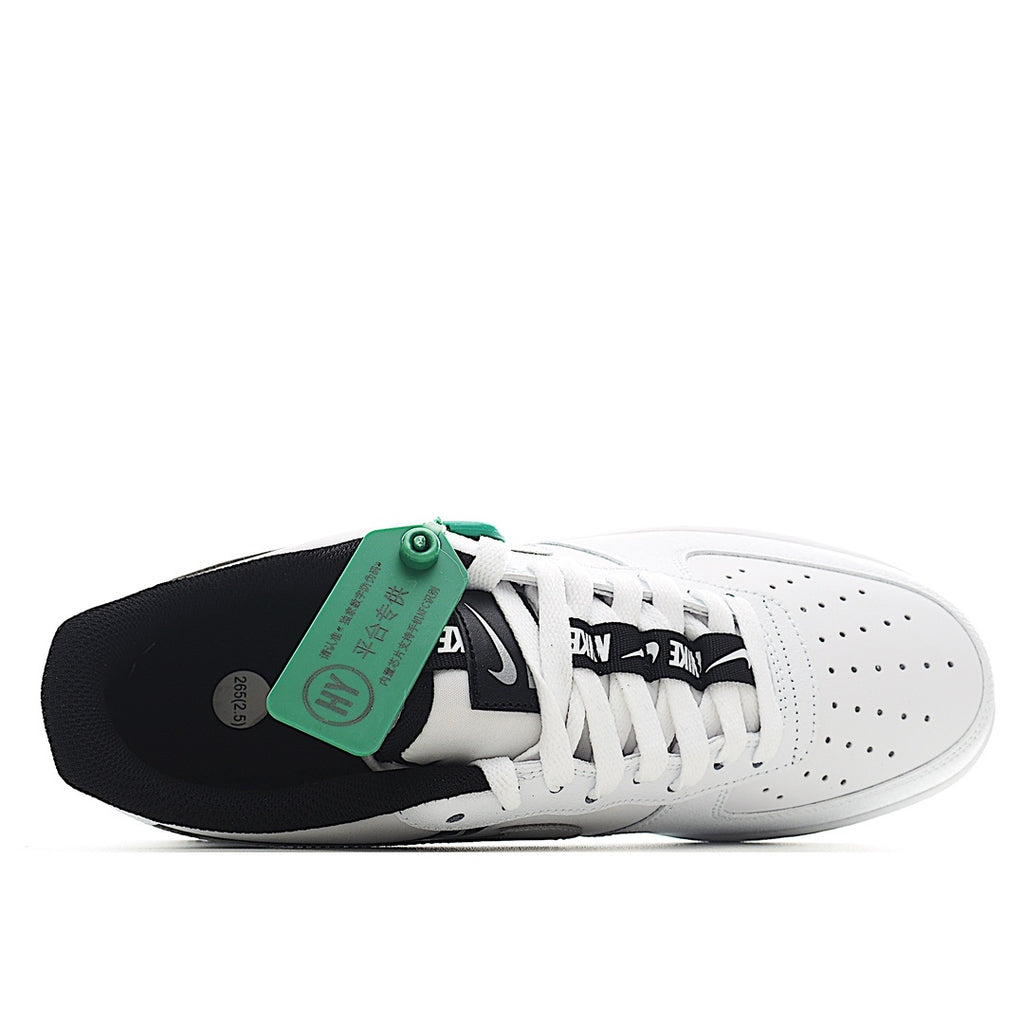White Nike Air Force 1 sneakers with black accents and green heel strap.