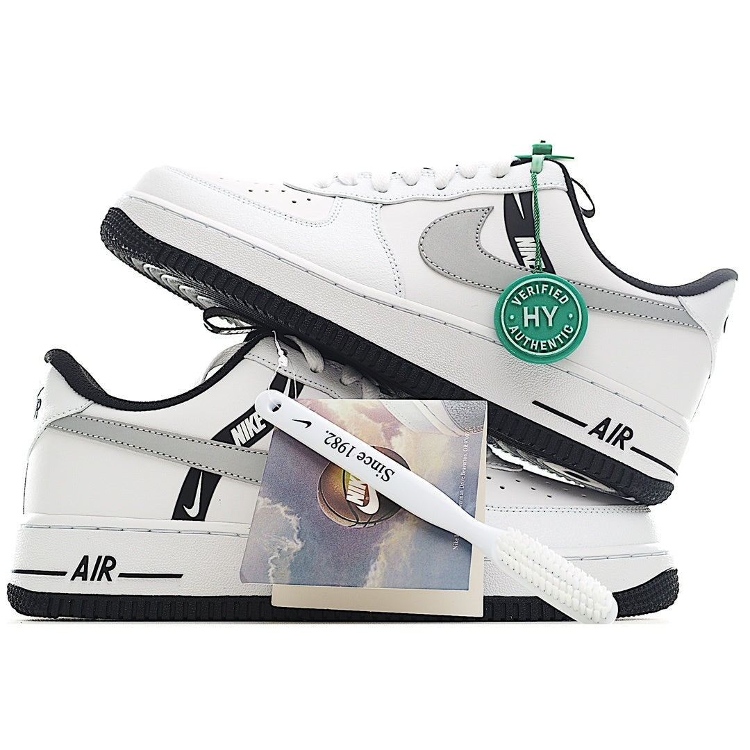 White Nike Air Force 1 sneakers with gray swoosh, green lace tag, black sole.