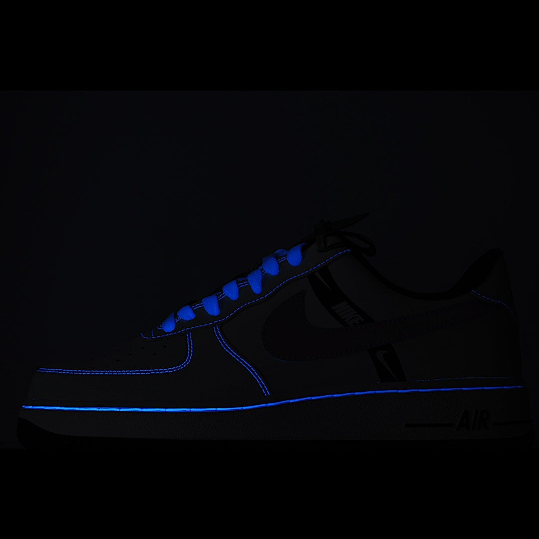 Black Nike sneakers with blue glowing line accents and Nike Air branding.