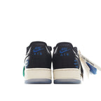 Nike Air Force 1 low sneakers, back view; black leather with white midsoles, green accents