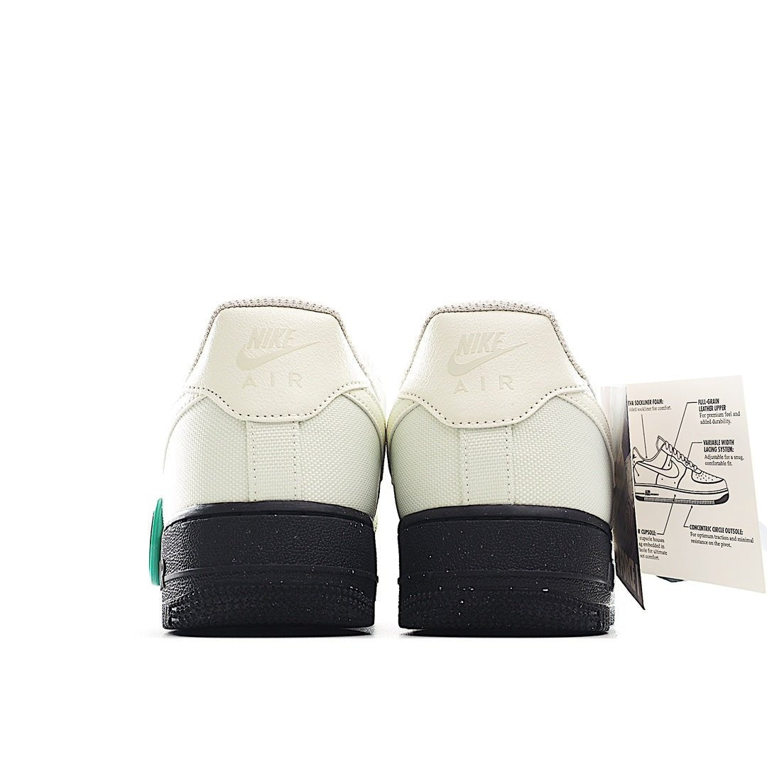 Pair of white sneakers with teal heel accents and black heel tabs