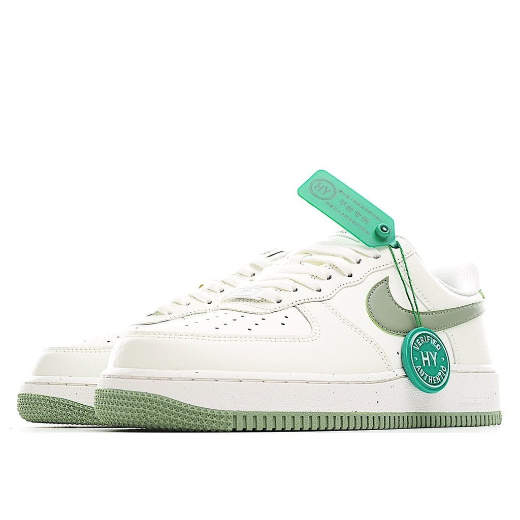 White low-top sneaker with olive-green Swoosh, green trim, and lace-up front