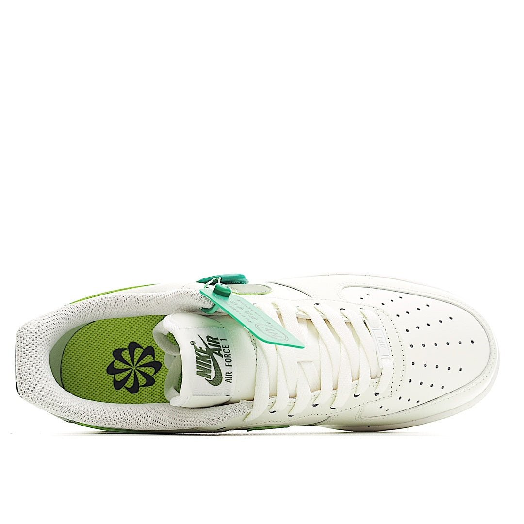 White sneaker viewed from side with olive-green inner panel and green outsole