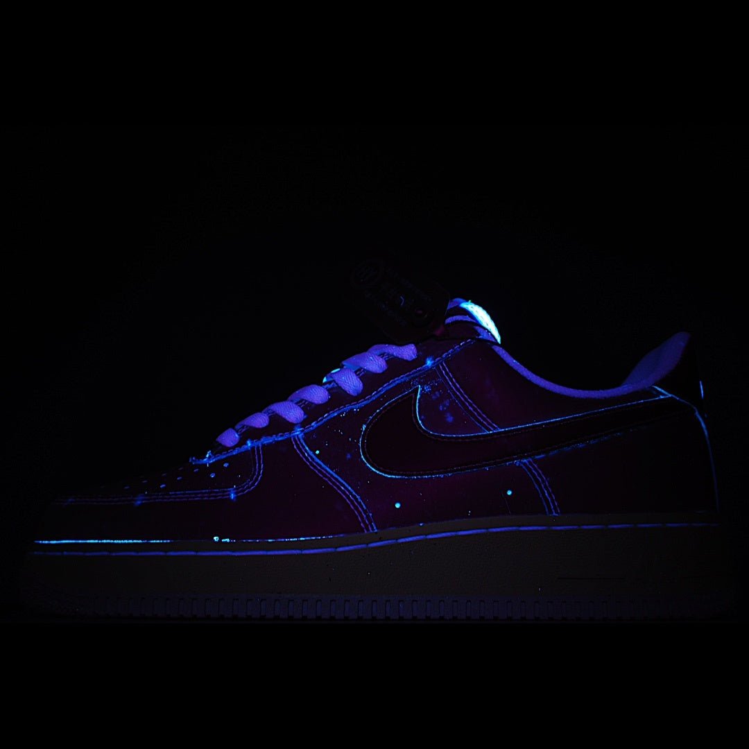 Dark blue low-top sneaker with black Swoosh and glowing blue trim