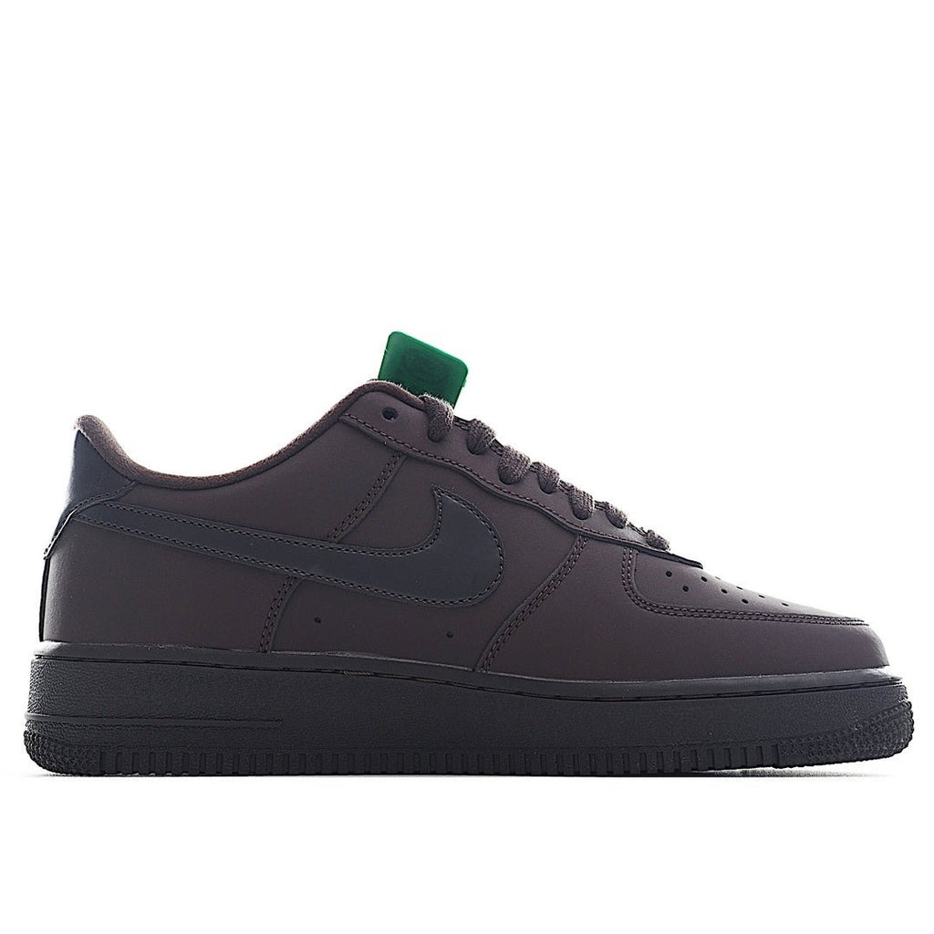 Air Force 1 sneakers, dark upper with perforations, black sole, green collar tab.