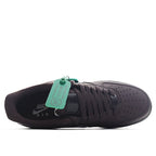 Air Force 1 sneakers, dark colorway with black laces and green hang tag at tongue.