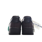 Air Force 1 sneakers, dark leather with green side detail at heel and rear pull tab.