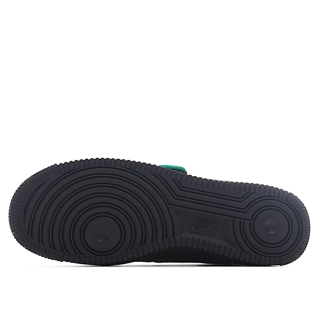 Air Force 1 outsole with dark traction tread and green accent on heel edge.
