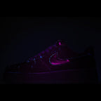 Air Force 1 sneakers in dark purple tones with subtle purple swoosh and sole.