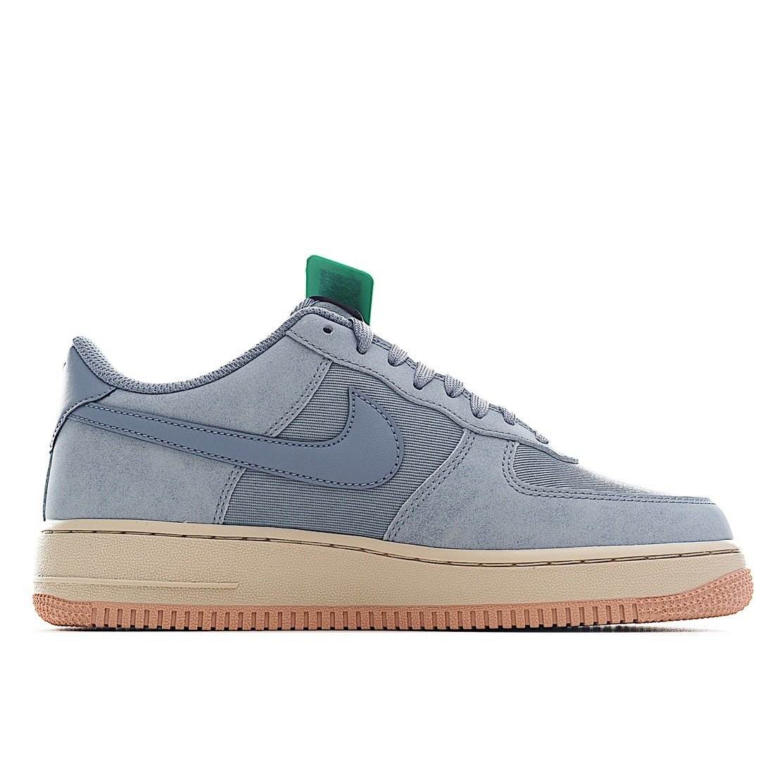 Nike Air Force 1 low-top sneakers in light blue with green tongue tag and gum sole