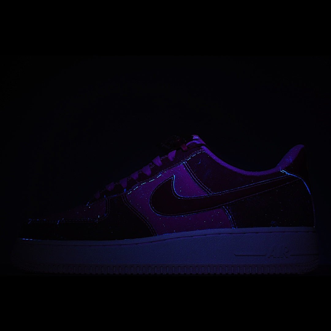 Dark low-top sneaker upper with purple glow lighting and visible swoosh