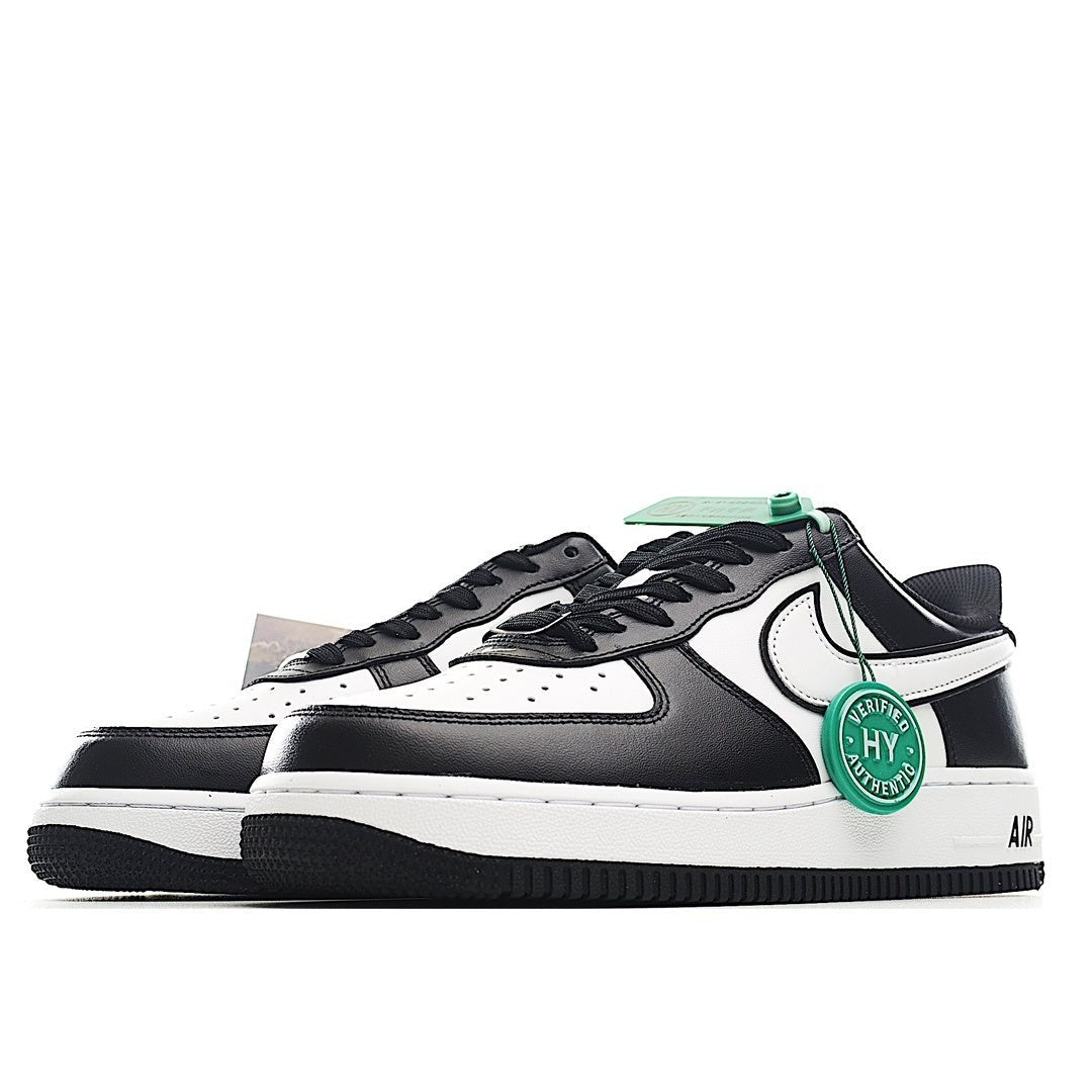 Side view black and white Air Force 1 low-top sneakers with green authenticity seal