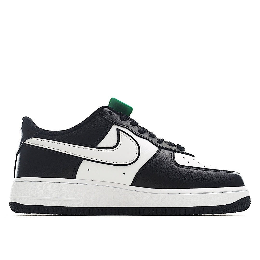 Black and white low-top sneakers with white Nike swoosh and green lace tag