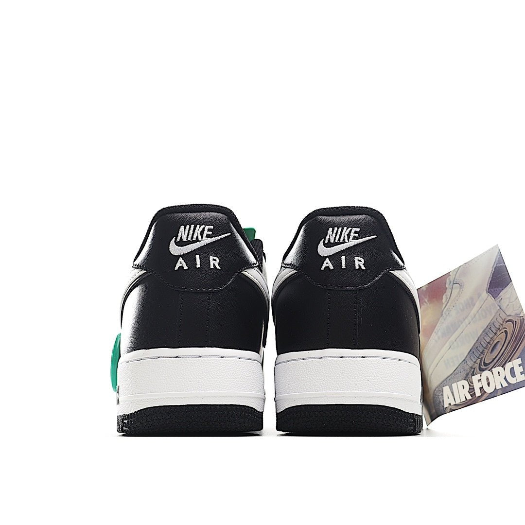 Pair of black Air Force 1 low-top sneakers with white midsoles and Nike Air heel text
