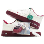 Nike Air Force 1 low-top sneakers, white with maroon outsole, green/red lace tag
