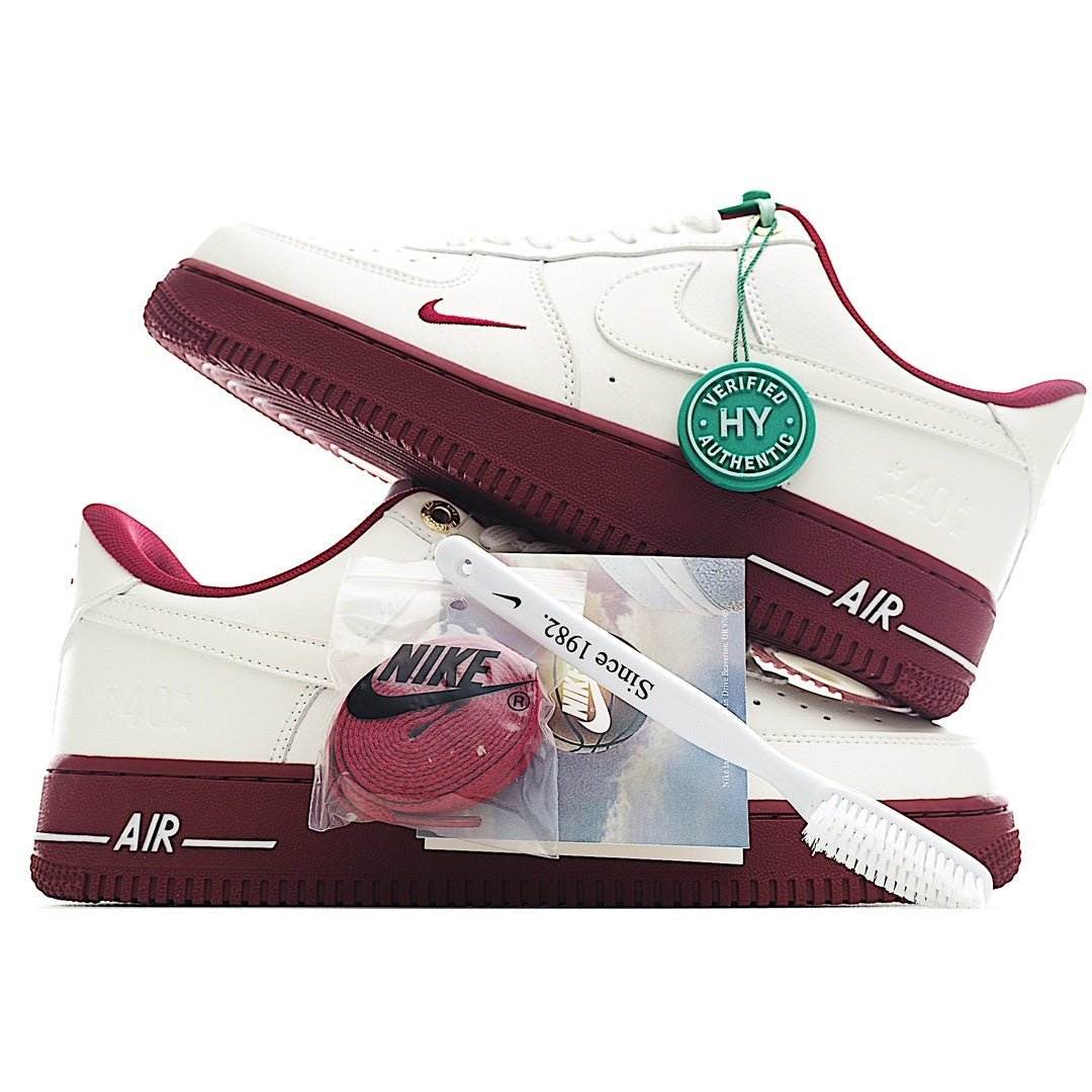 Nike Air Force 1 low-top sneakers, white with maroon outsole, green/red lace tag