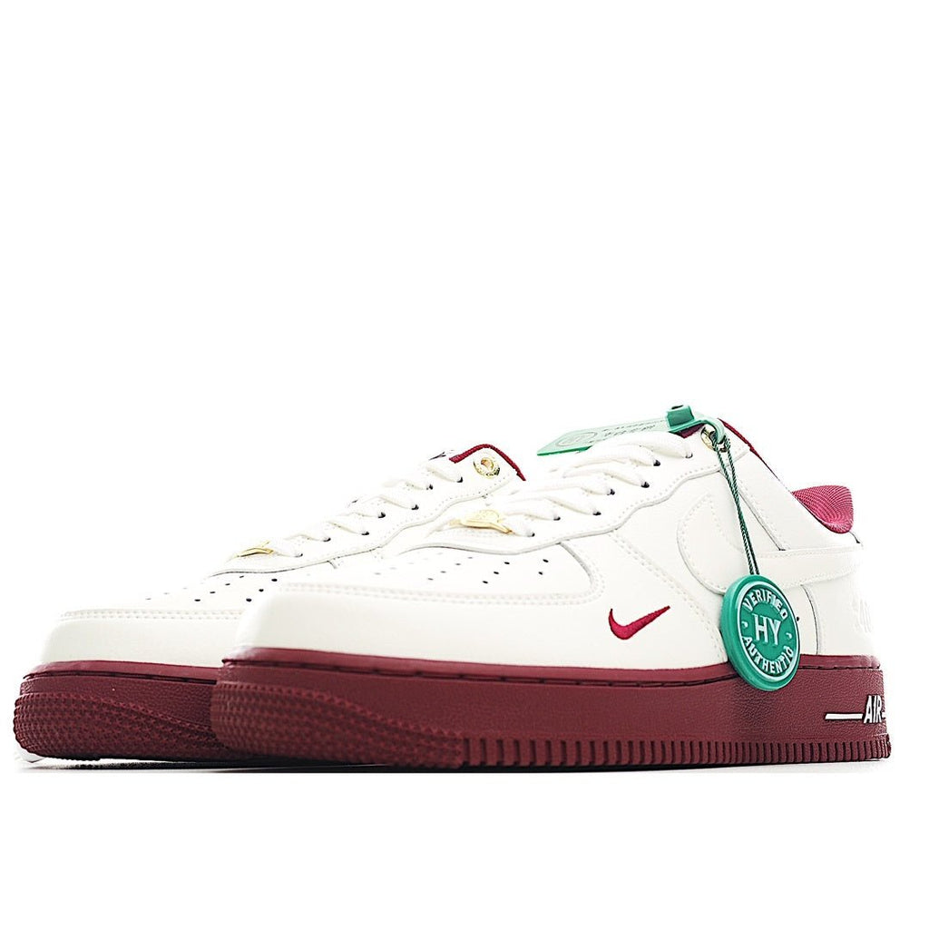 White Air Force 1 sneakers with burgundy side panels, green lace tag, and red swoosh