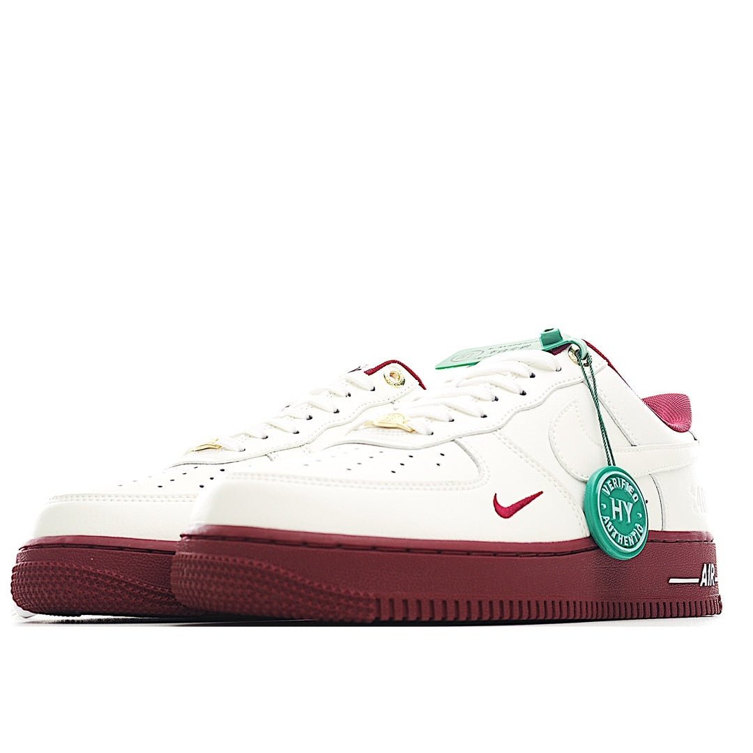 White Air Force 1 sneakers with burgundy side panels, green lace tag, and red swoosh