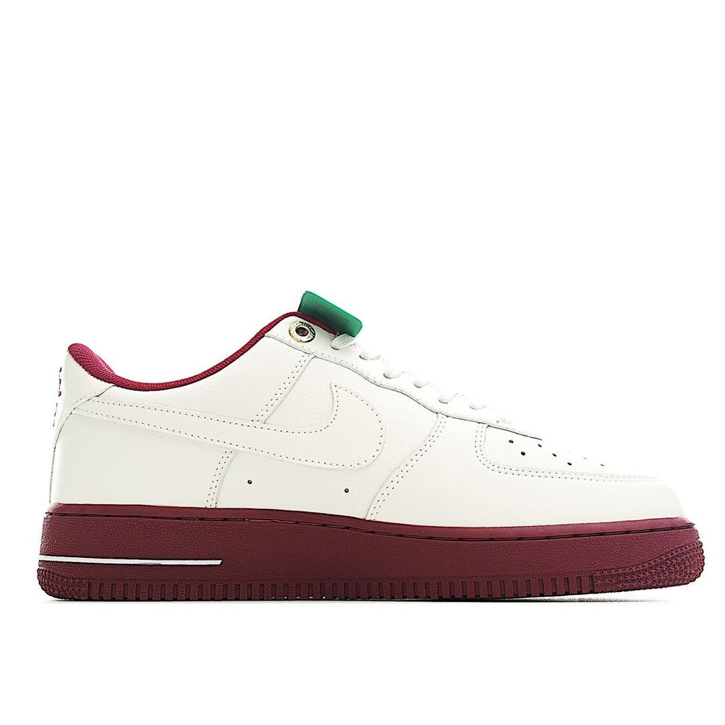 White Air Force 1 sneaker with green lace detail and burgundy midsole