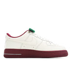 White Air Force 1 sneaker with green lace detail and burgundy midsole