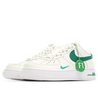 White and green low-top sneakers, side view with green swoosh