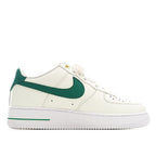 White low-top sneakers with green swoosh and lace-up front